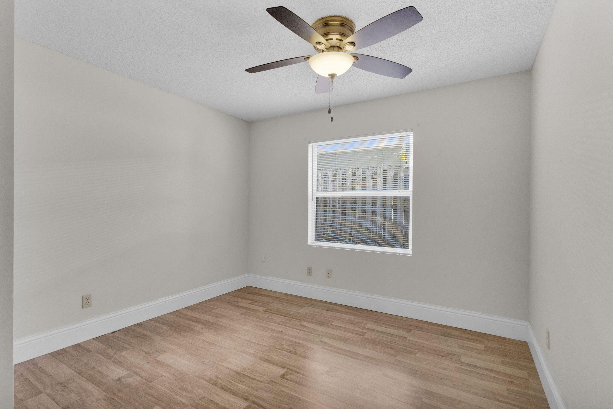 8888 Southeast Colony Street Hobe Sound, FL 33455 - Photo 27 of 69 an empty room with a window and a fan