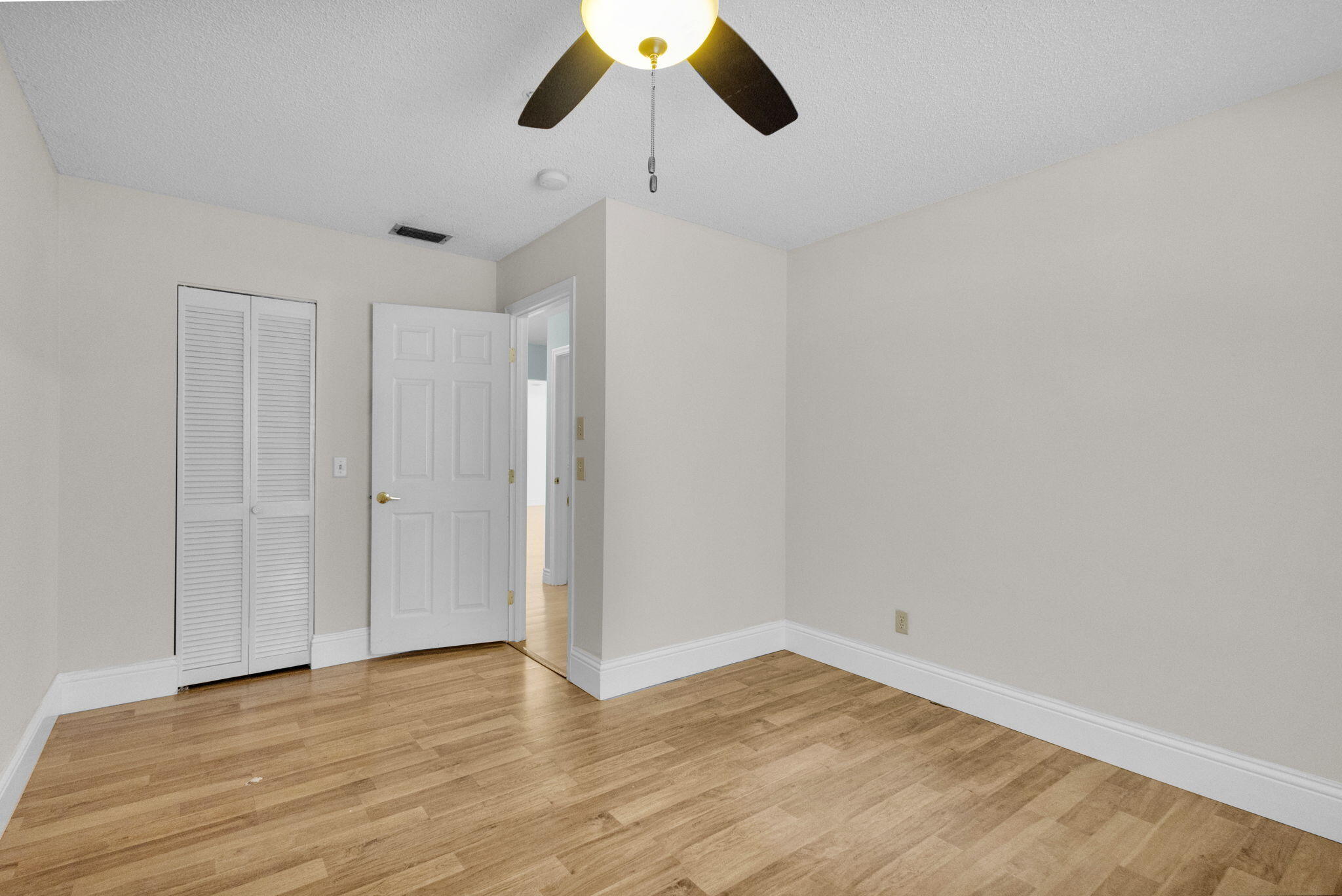 8888 Southeast Colony Street Hobe Sound, FL 33455 - Photo 28 of 69 a view of empty room with wooden floor