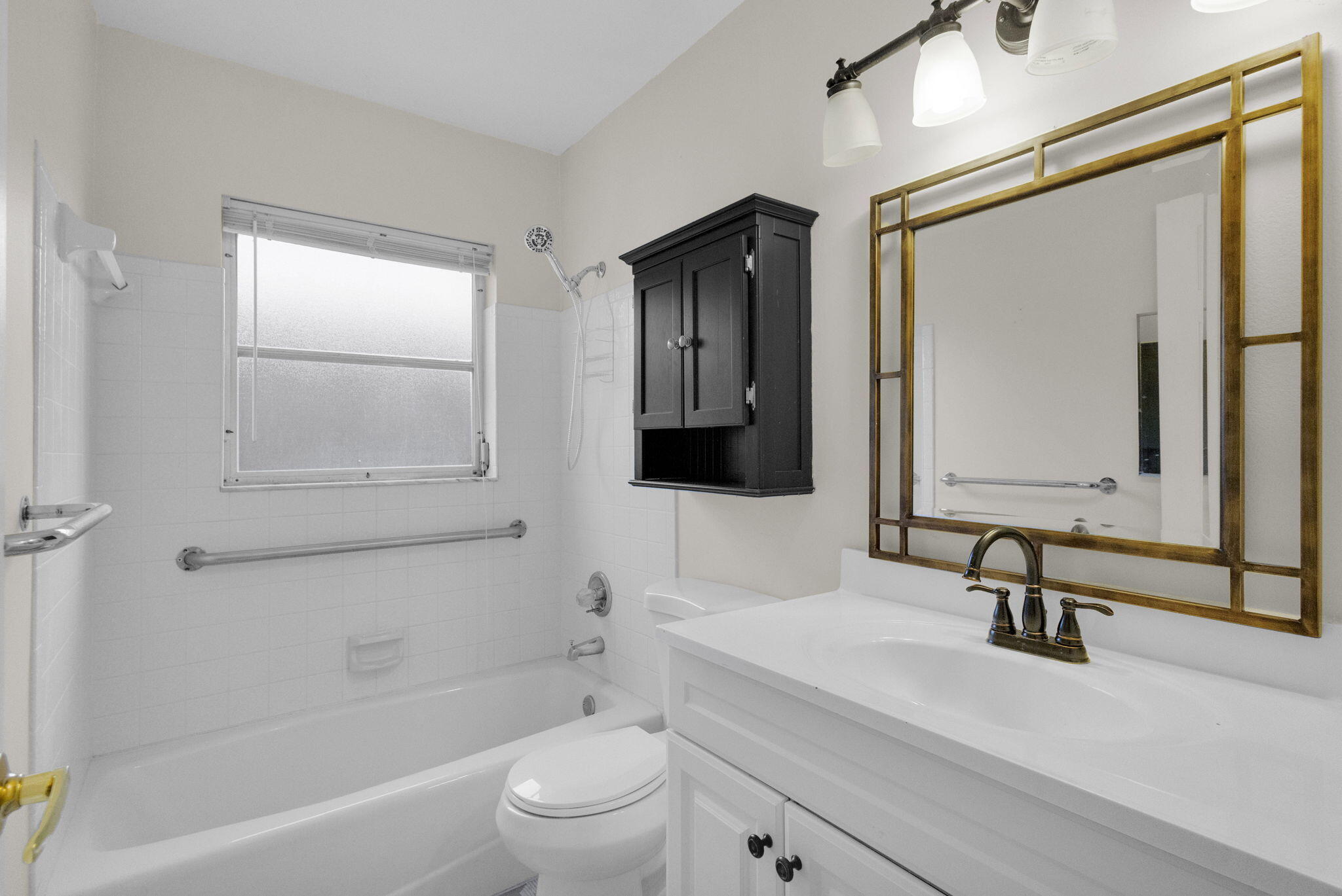 8888 Southeast Colony Street Hobe Sound, FL 33455 - Photo 29 of 69 a bathroom with a sink a toilet and shower