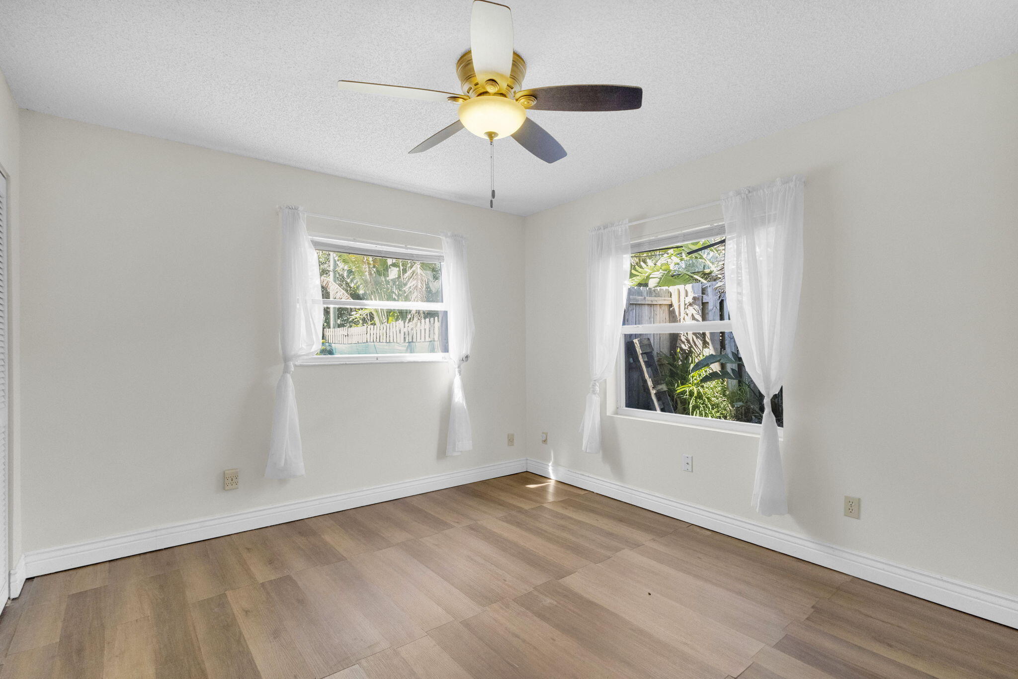 8888 Southeast Colony Street Hobe Sound, FL 33455 - Photo 31 of 69 wooden floor in an empty room with a window