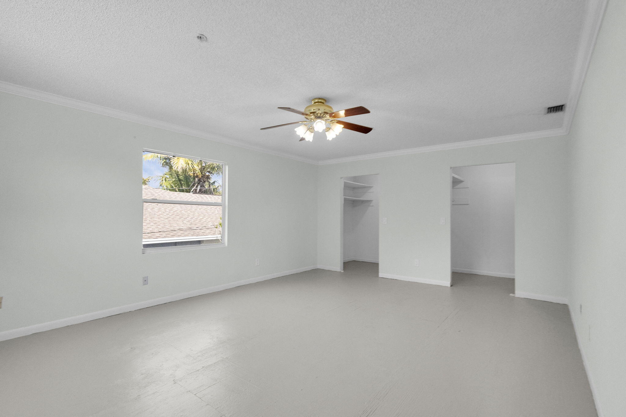 8888 Southeast Colony Street Hobe Sound, FL 33455 - Photo 33 of 69 an empty room with a window and a fan