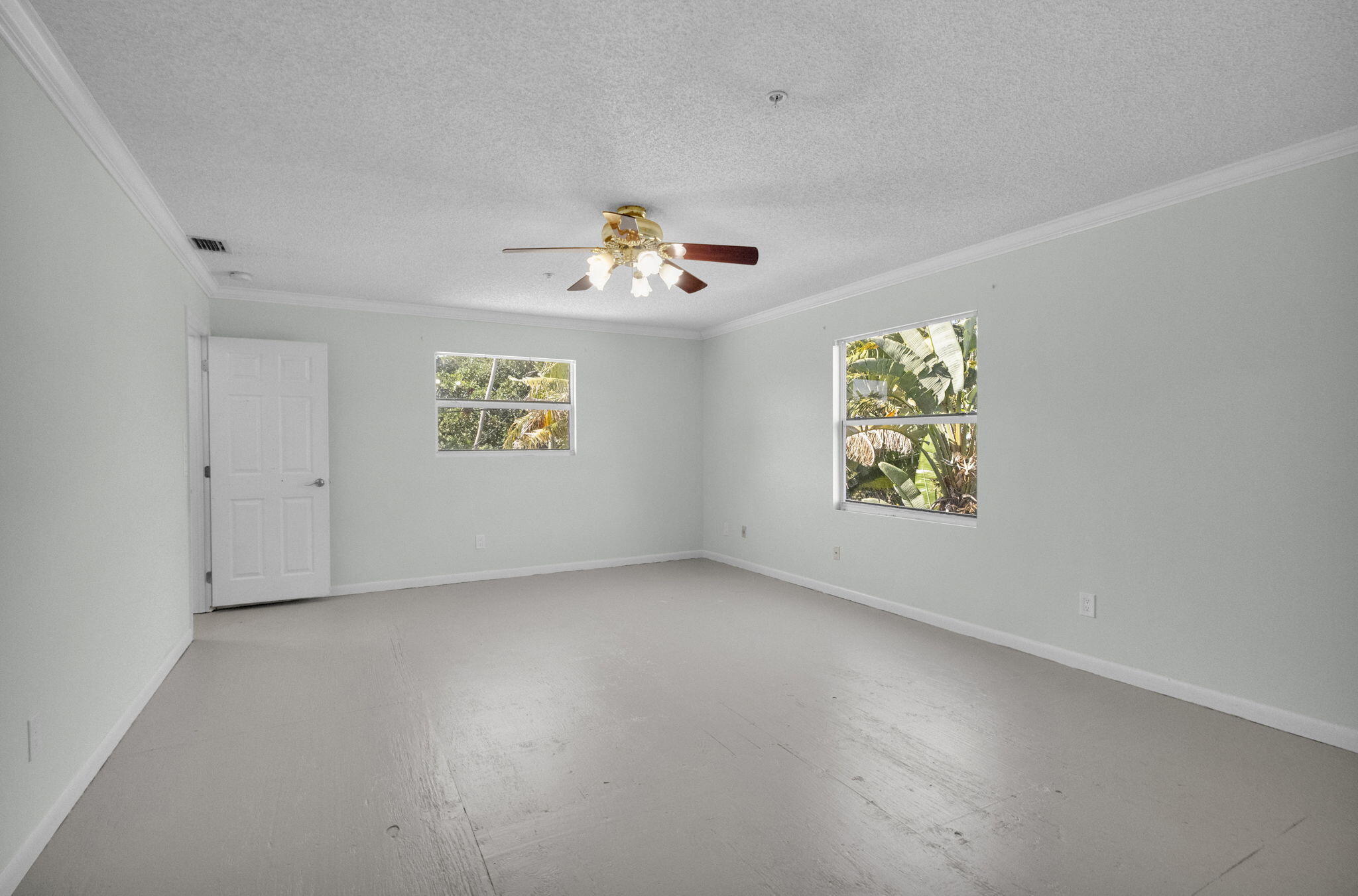 8888 Southeast Colony Street Hobe Sound, FL 33455 - Photo 34 of 69 an empty room with windows and painted walls