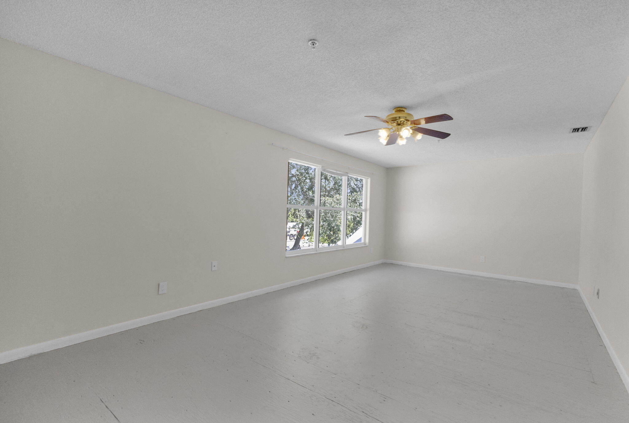 8888 Southeast Colony Street Hobe Sound, FL 33455 - Photo 36 of 69 an empty room with a window and a fan