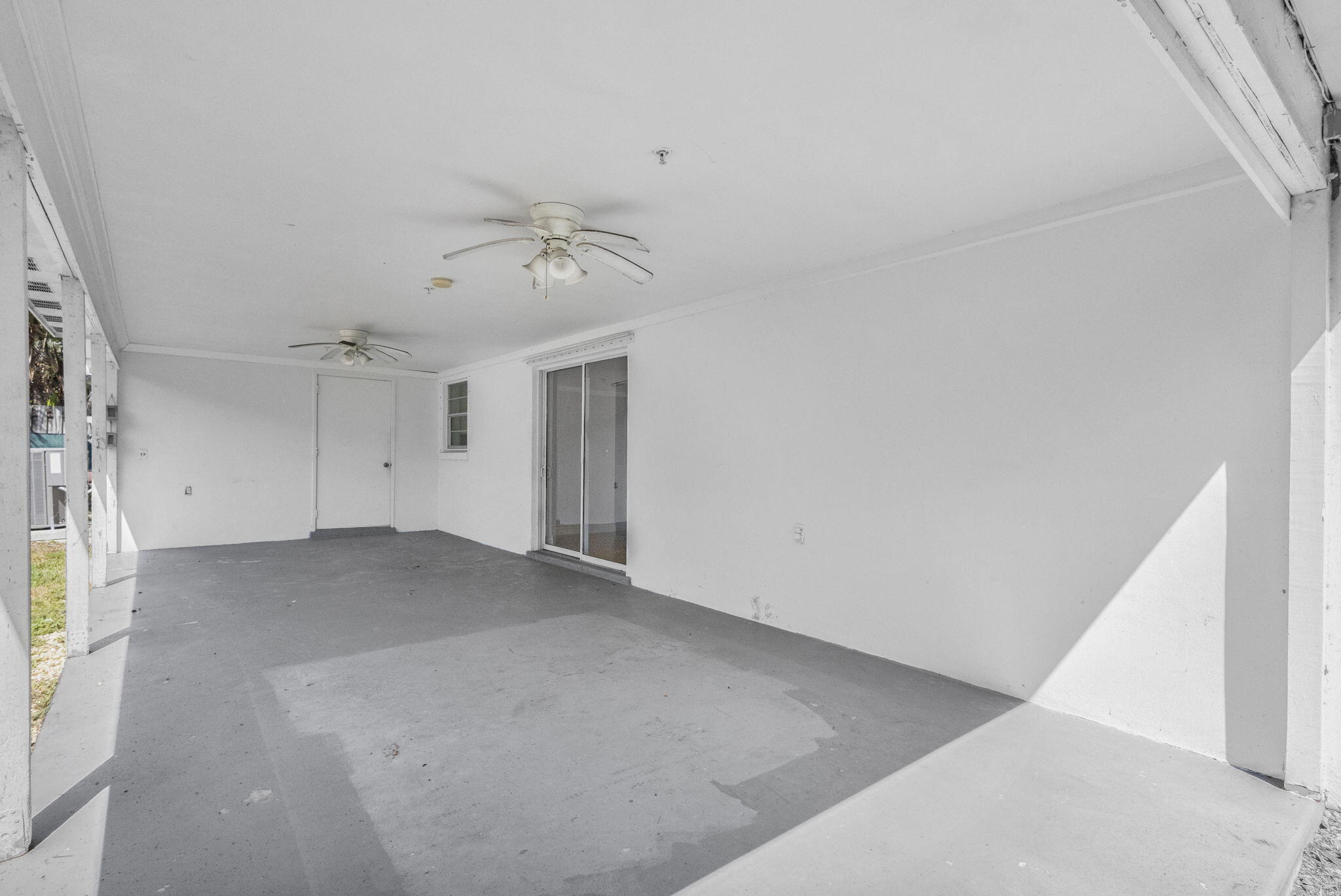 8888 Southeast Colony Street Hobe Sound, FL 33455 - Photo 49 of 69 a view of a big room with chandelier fan and windows