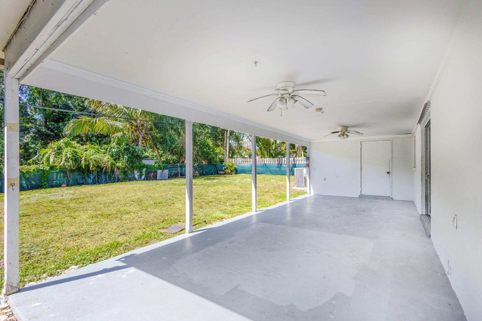 8888 Southeast Colony Street Hobe Sound, FL 33455 - Photo 50 of 69 a view of an empty room with a floor to ceiling window and a lake view