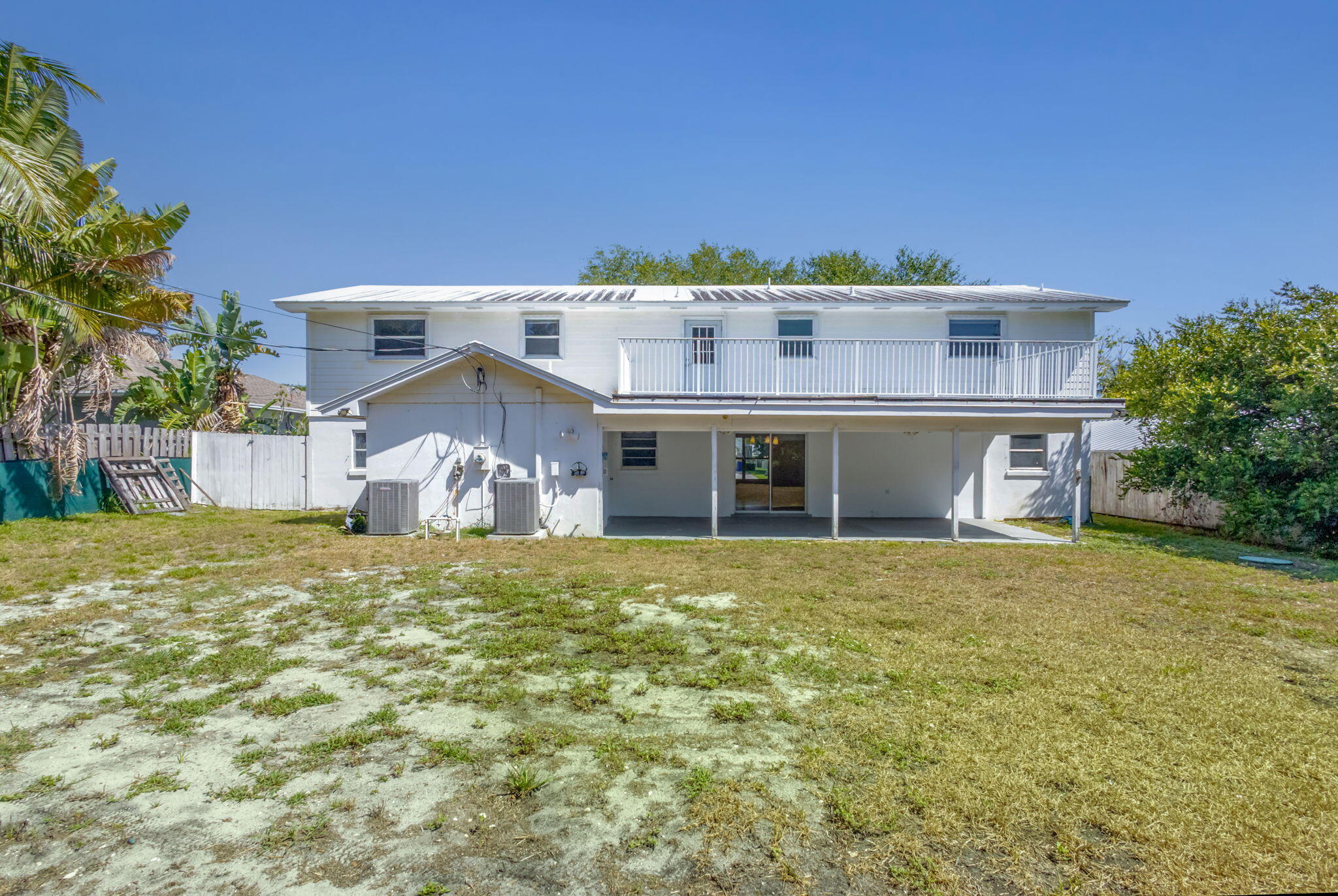 8888 Southeast Colony Street Hobe Sound, FL 33455 - Photo 52 of 69 a front view of a house with a yard