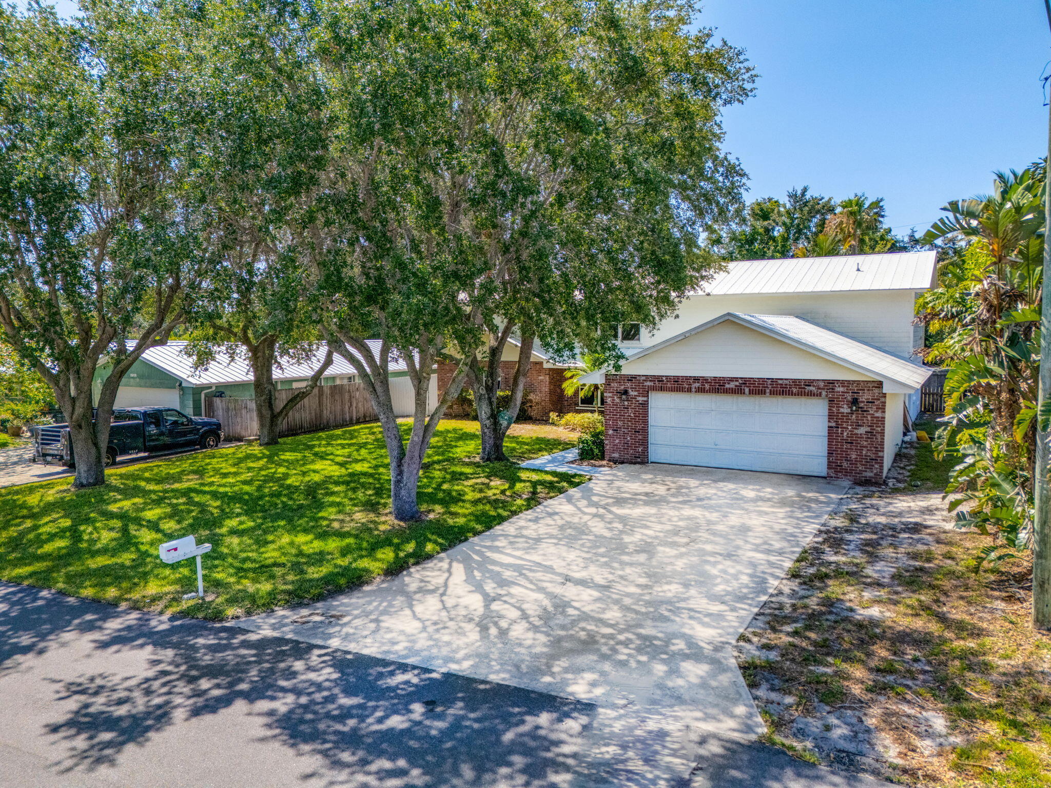 8888 Southeast Colony Street Hobe Sound, FL 33455 - Photo 60 of 69 a front view of a house with a yard and a garage