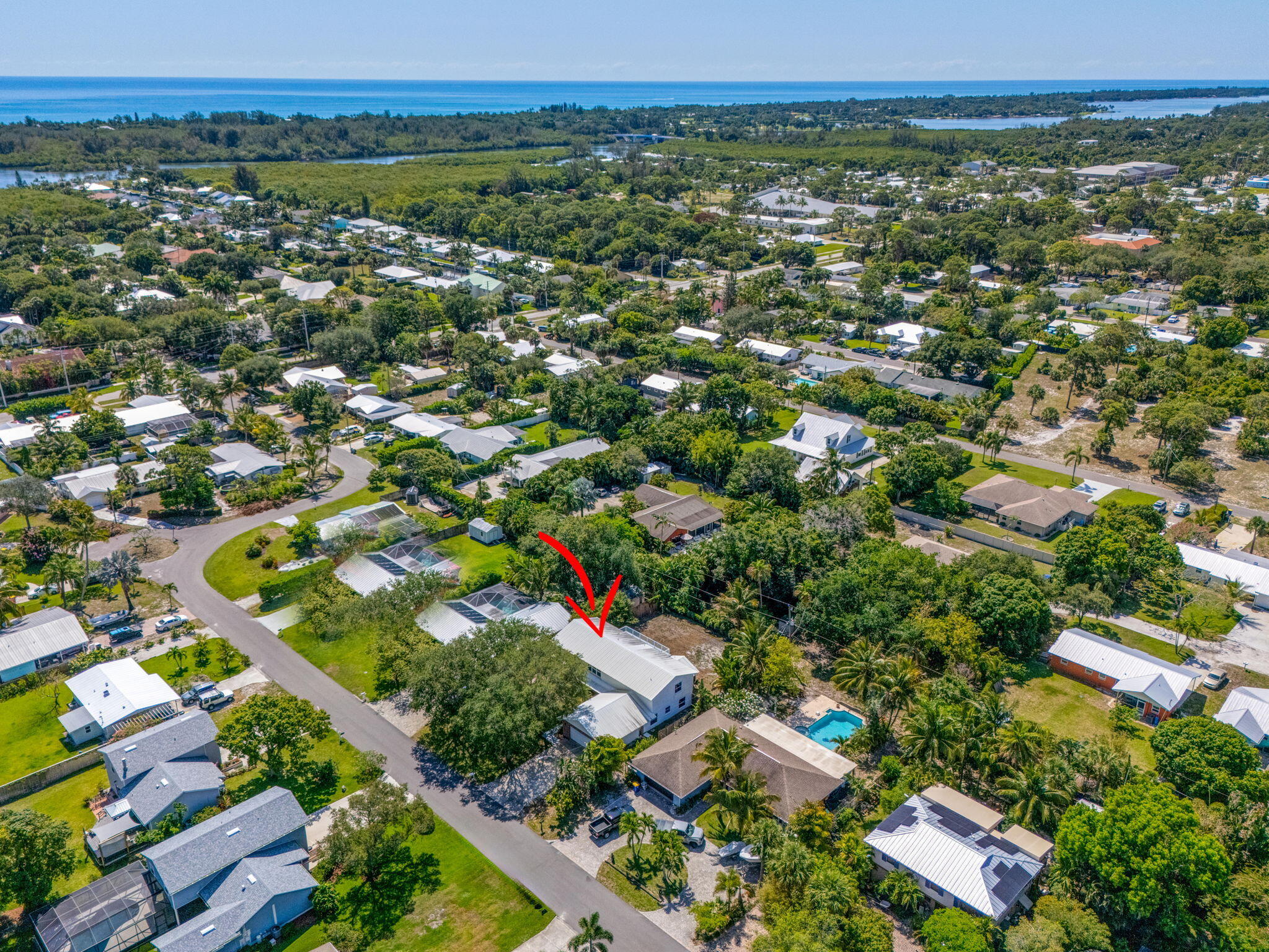 8888 Southeast Colony Street Hobe Sound, FL 33455 - Photo 62 of 69 an aerial view of residential houses with outdoor space and trees