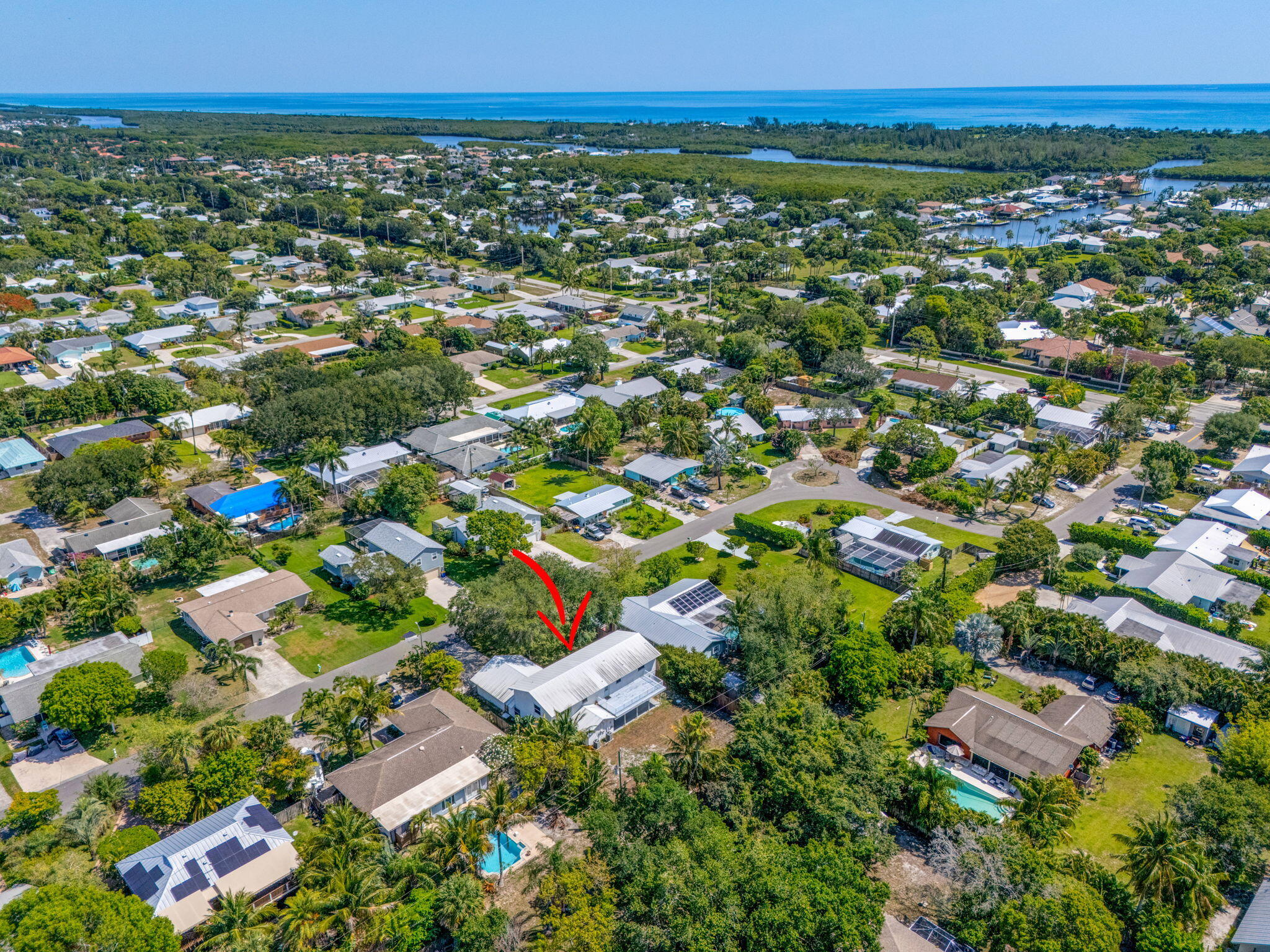 8888 Southeast Colony Street Hobe Sound, FL 33455 - Photo 64 of 69 an aerial view of residential houses with outdoor space and trees
