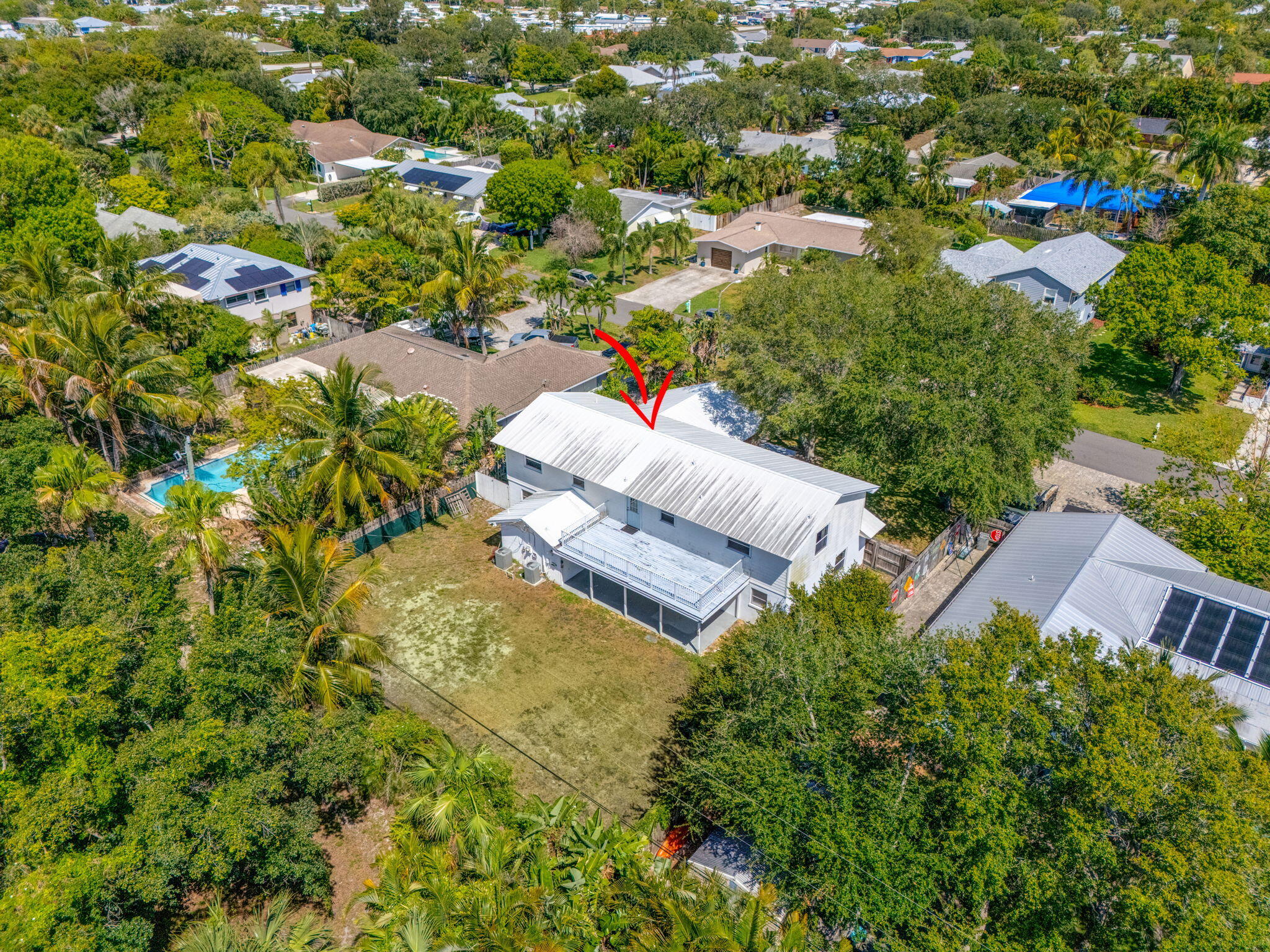 8888 Southeast Colony Street Hobe Sound, FL 33455 - Photo 66 of 69 an aerial view of a house with a yard and lake view