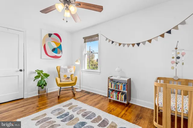 a living room with fireplace furniture and a wooden floor