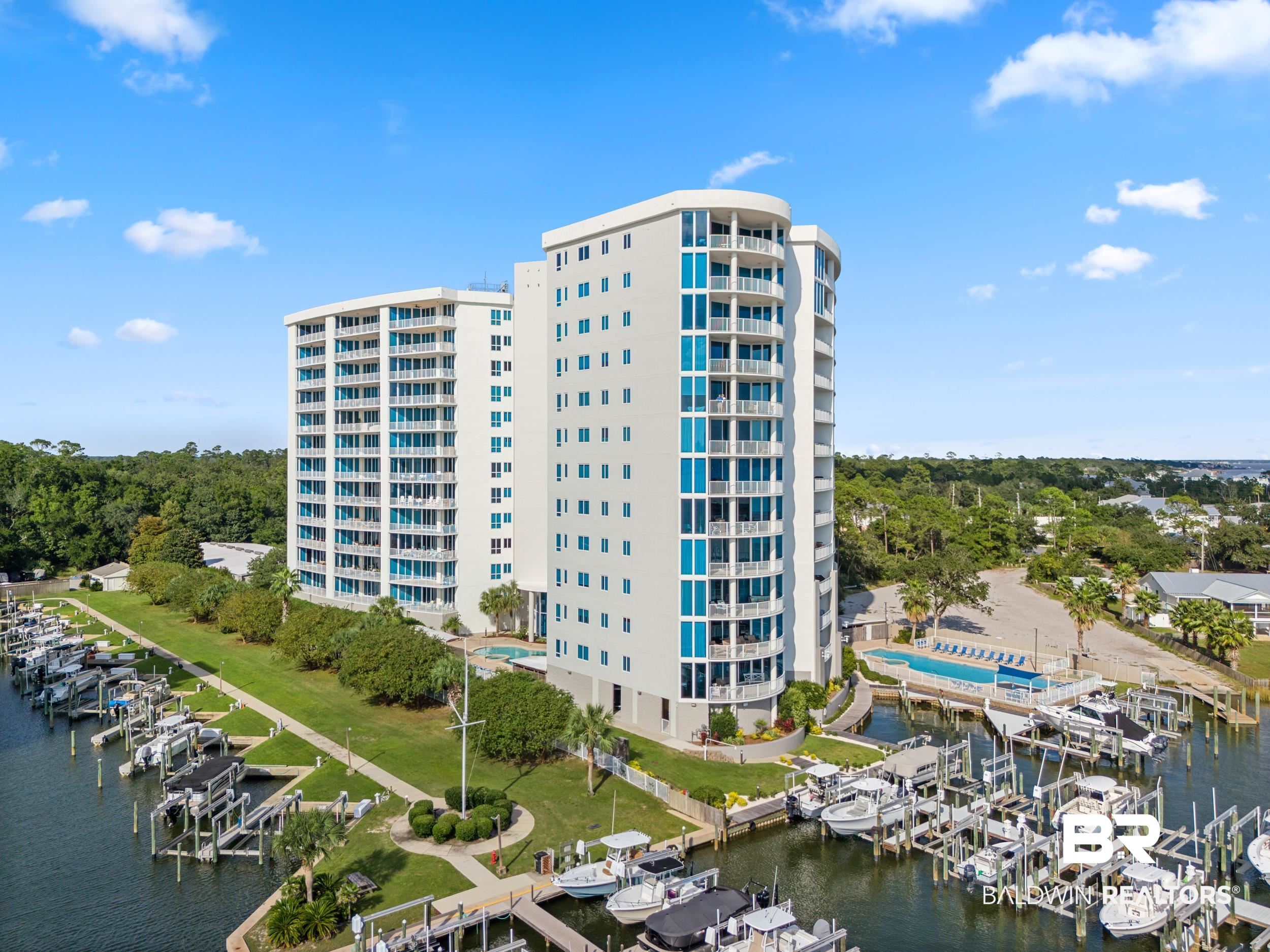 28250 Canal Road, Unit 307 Orange Beach, AL 36561 - Photo 3 of 56 View of apartment building / complex with boat lift, view of marina, and a water view