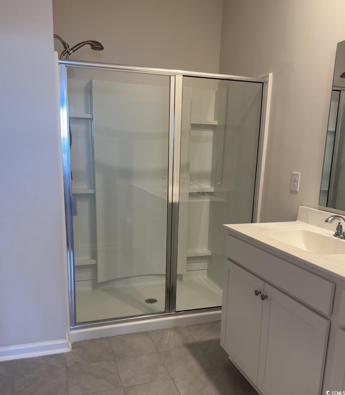 3789 Bells Lk Circle Longs, SC 29568 - Photo 13 of 26 Full bathroom with a shower stall, vanity, and light tile patterned floors