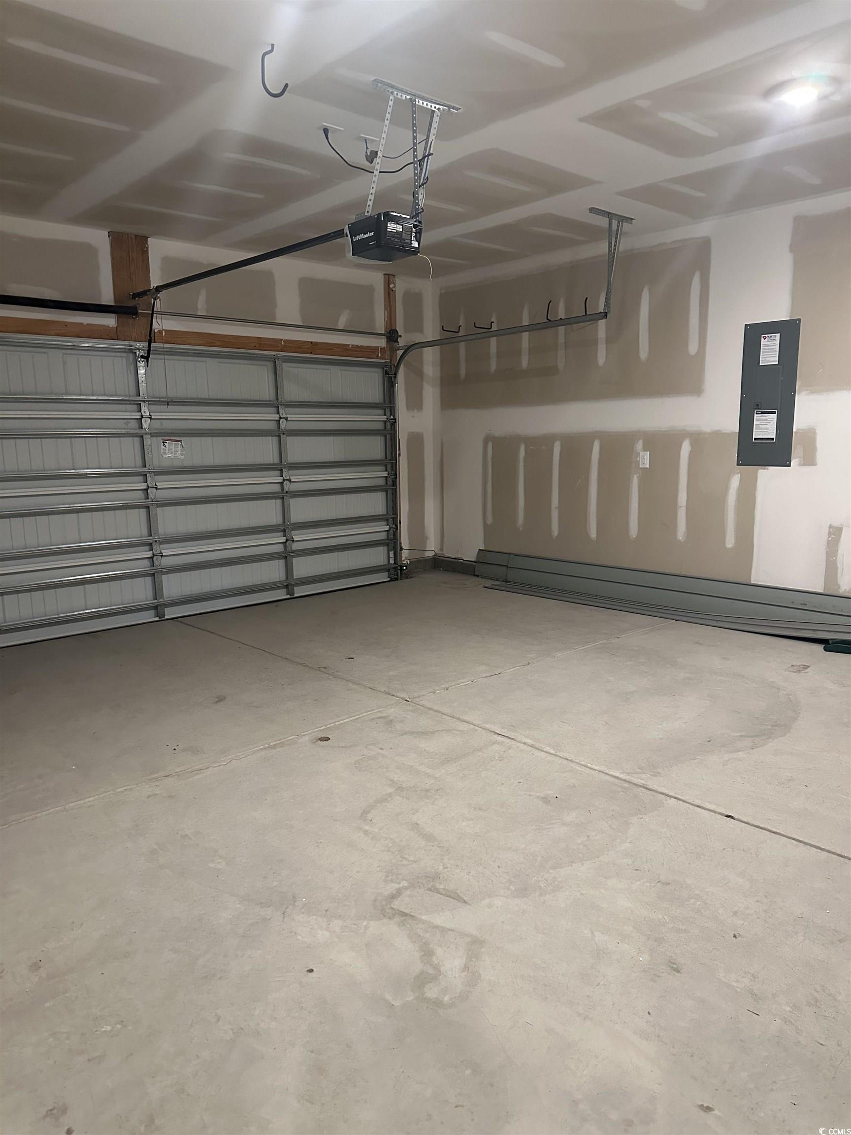 3789 Bells Lk Circle Longs, SC 29568 - Photo 24 of 26 Garage featuring electric panel and a garage door opener