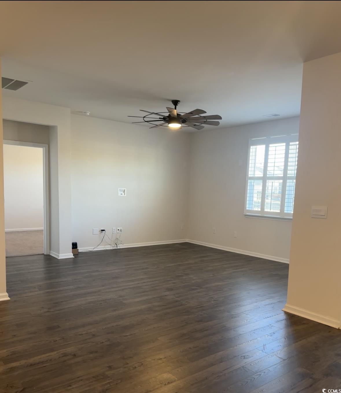 3789 Bells Lk Circle Longs, SC 29568 - Photo 7 of 26 Spare room featuring dark wood finished floors and ceiling fan