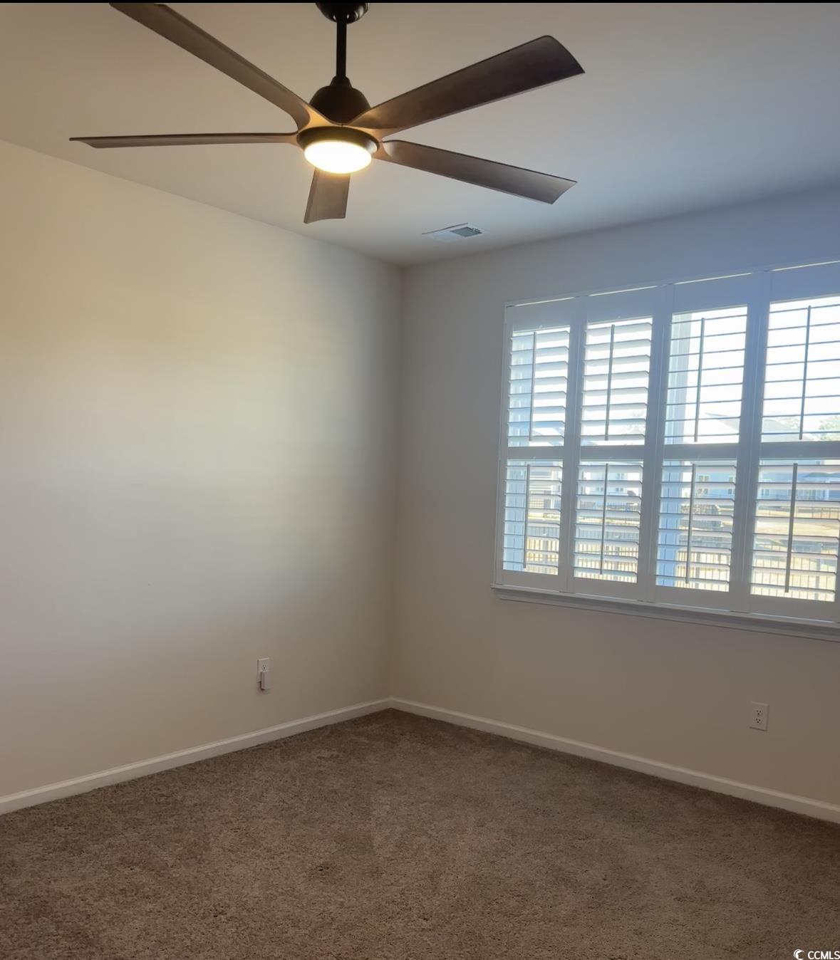 3789 Bells Lk Circle Longs, SC 29568 - Photo 10 of 26 Spare room featuring dark colored carpet and ceiling fan