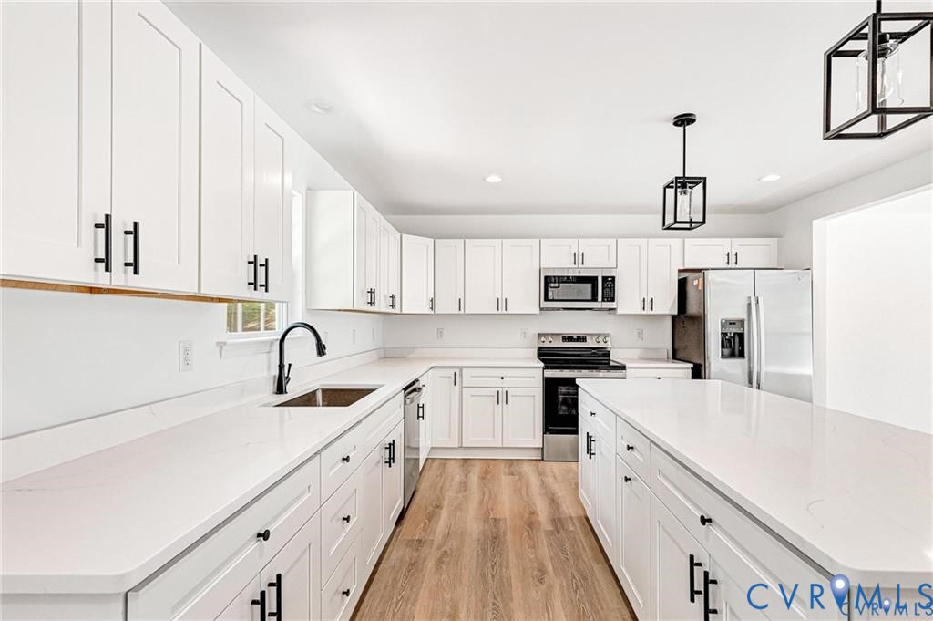 512 Freedom Drive Ruther Glen, VA 22546 - Photo 12 of 36 a kitchen with white cabinets sink and white appliances