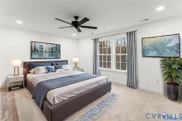 a spacious bedroom with a bed and a potted plant