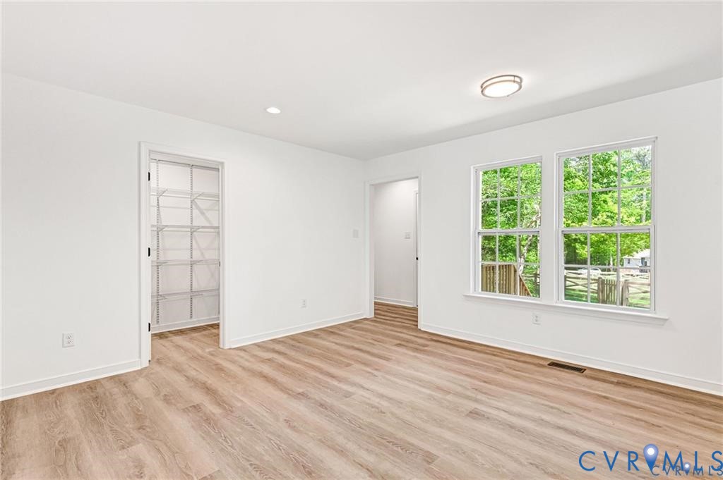 512 Freedom Drive Ruther Glen, VA 22546 - Photo 14 of 36 an empty room with wooden floor and windows