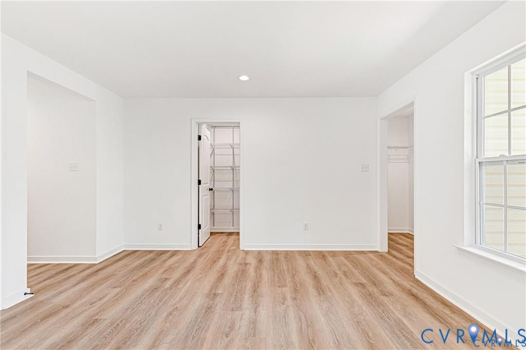 512 Freedom Drive Ruther Glen, VA 22546 - Photo 15 of 36 an empty room with wooden floor and windows
