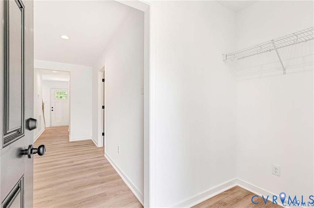 512 Freedom Drive Ruther Glen, VA 22546 - Photo 19 of 36 a view of a hallway with a hardwood floor and a bathroom