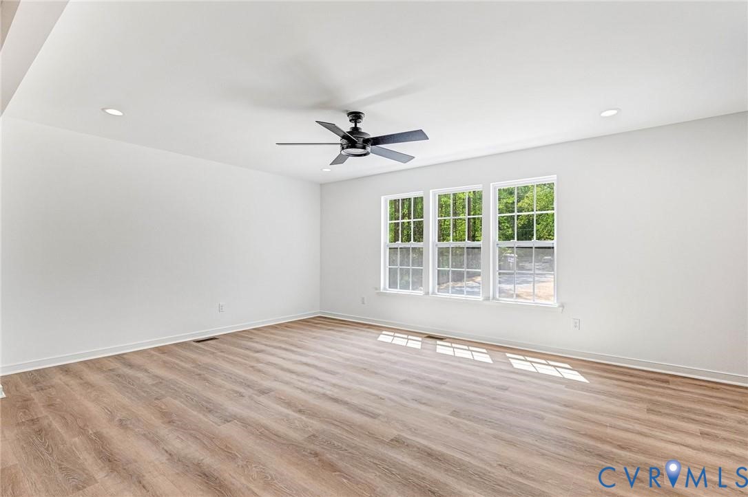 512 Freedom Drive Ruther Glen, VA 22546 - Photo 2 of 36 an empty room with wooden floor and ceiling fan
