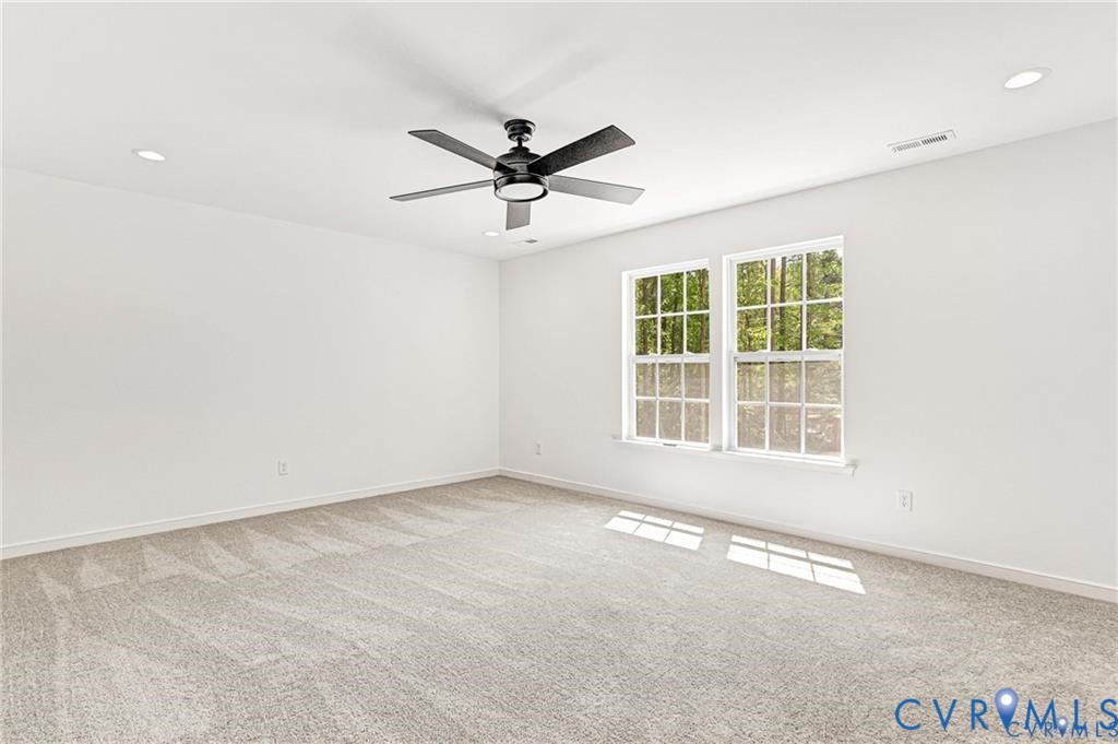 512 Freedom Drive Ruther Glen, VA 22546 - Photo 23 of 36 an empty room with a window and a fan