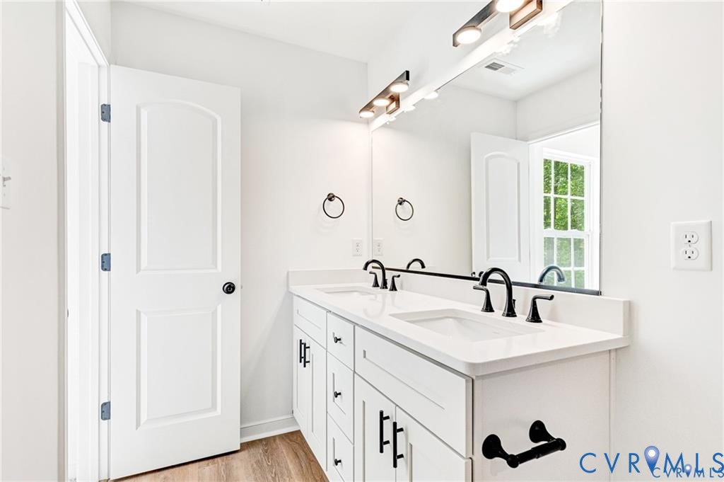 512 Freedom Drive Ruther Glen, VA 22546 - Photo 29 of 36 a bathroom with a double vanity sink and mirror