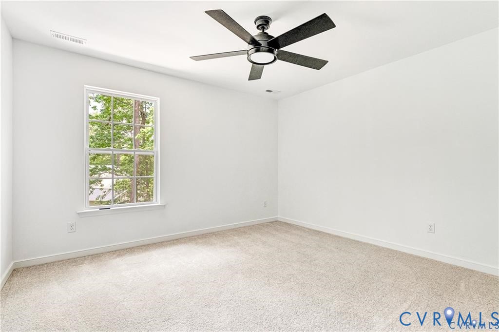 512 Freedom Drive Ruther Glen, VA 22546 - Photo 30 of 36 an empty room with a window and a fan