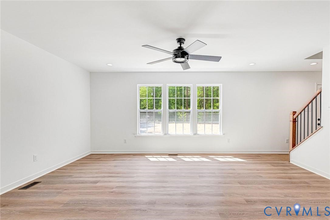 512 Freedom Drive Ruther Glen, VA 22546 - Photo 3 of 36 a view of an empty room with wooden floor and a window