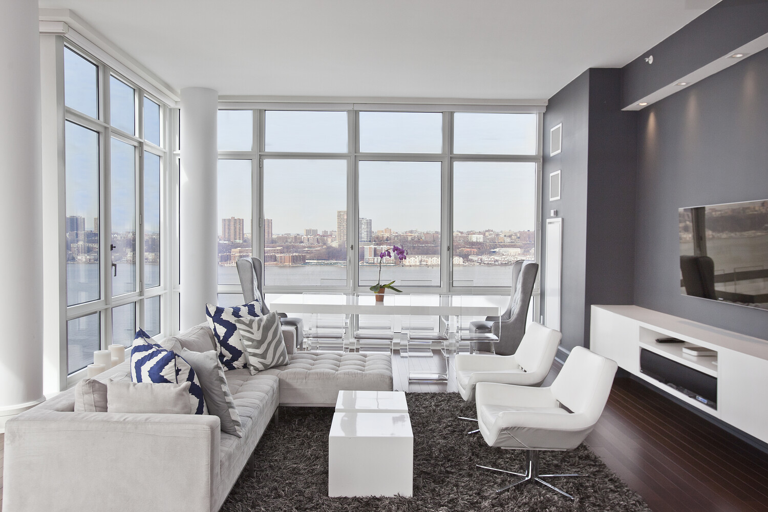 60 Riverside Boulevard, Unit 2011 Manhattan, NY 10069 - Photo 2 of 6 a living room with furniture and a large window