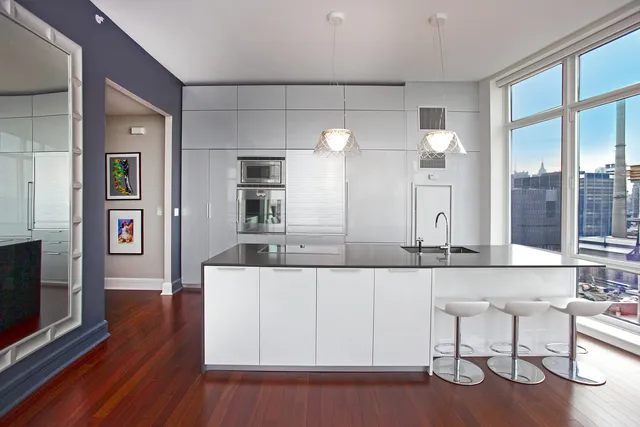 a large white kitchen with a large window
