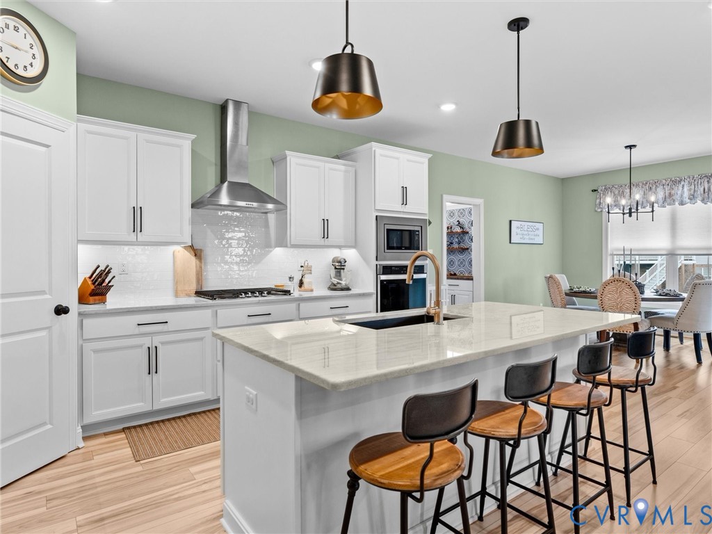 16106 Cambian Lane Chesterfield, VA 23832 - Photo 14 of 50 a kitchen with stainless steel appliances a stove a table and chairs