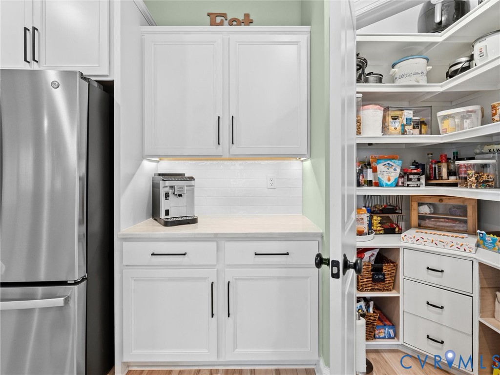 16106 Cambian Lane Chesterfield, VA 23832 - Photo 21 of 50 a kitchen with white cabinets and refrigerator