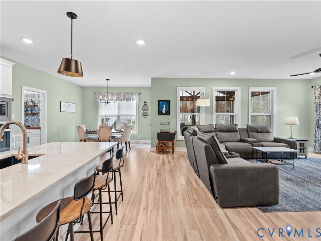 16106 Cambian Lane Chesterfield, VA 23832 - Photo 22 of 50 a living room with furniture a wooden floor and a chandelier