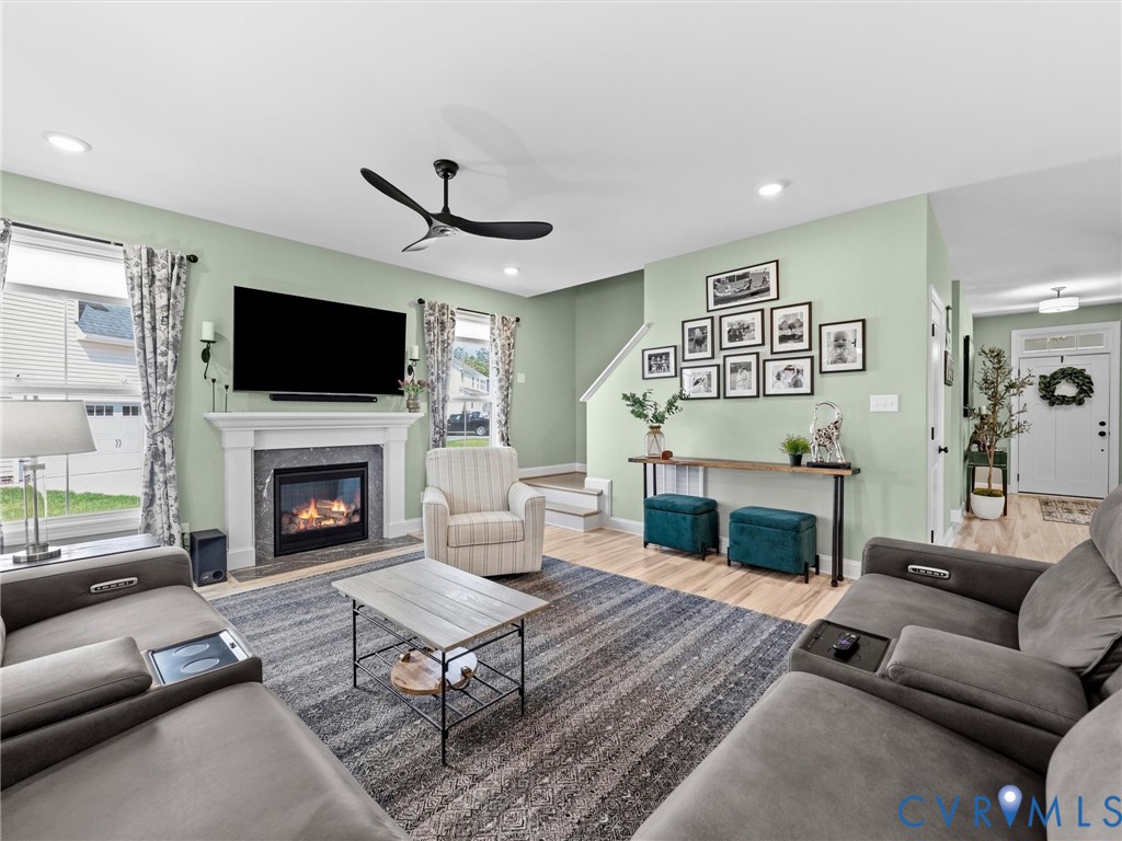 16106 Cambian Lane Chesterfield, VA 23832 - Photo 25 of 50 a living room with furniture a flat screen tv and a fireplace