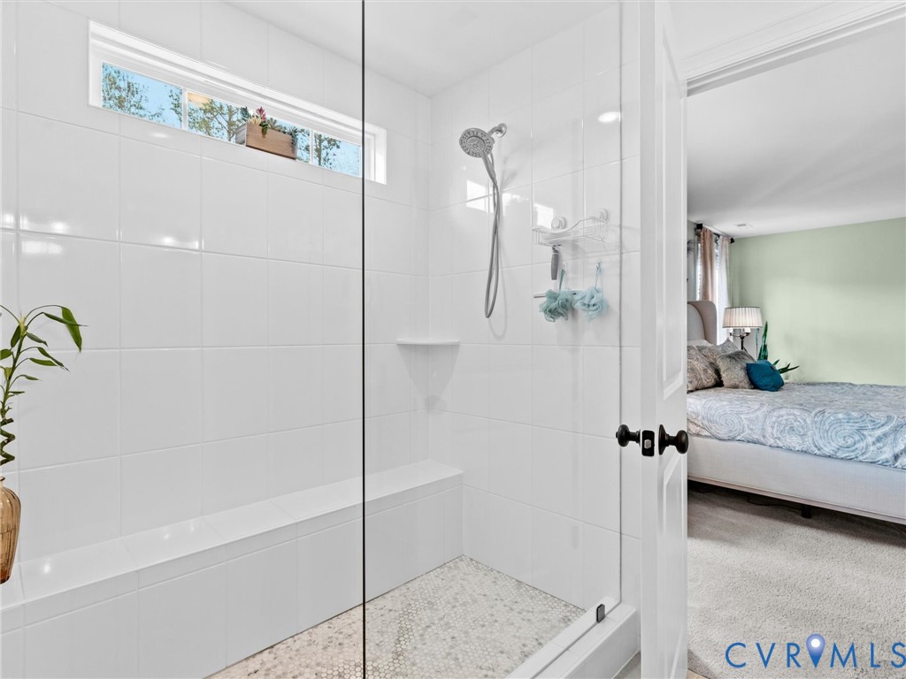 16106 Cambian Lane Chesterfield, VA 23832 - Photo 34 of 50 a spacious bathroom with a granite countertop shower a mirror and bathtub