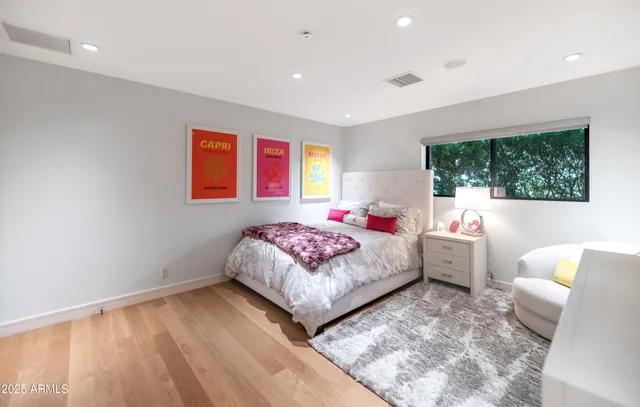 a bedroom with a bed and a large window