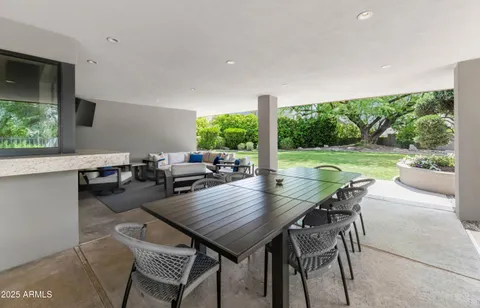 a view of a patio with table and chairs
