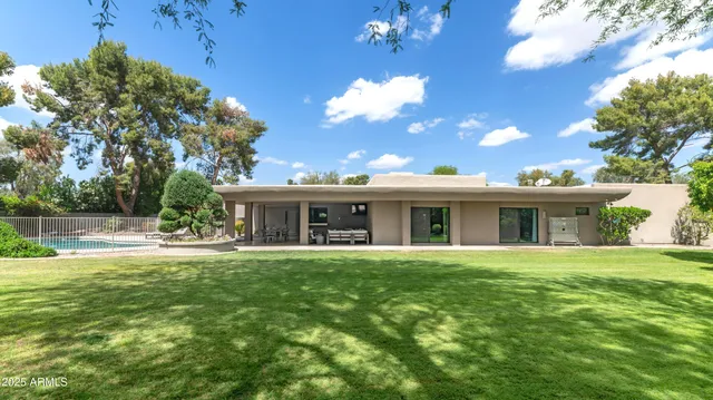 a view of a house with a yard and potted plants