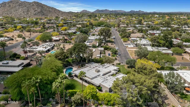 an aerial view of a house with a garden and swimming pool