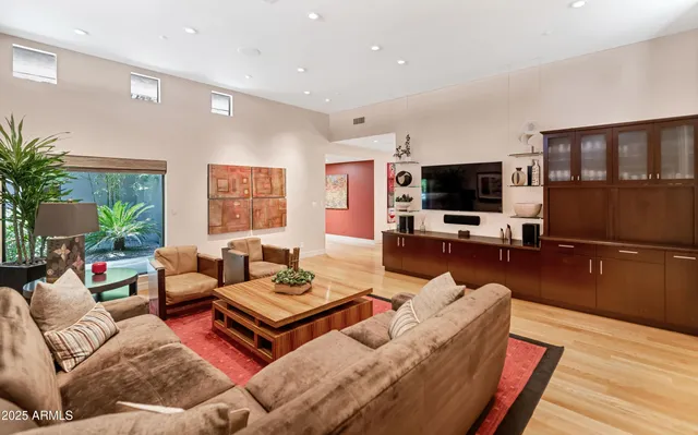 a living room with furniture a large window and a flat screen tv