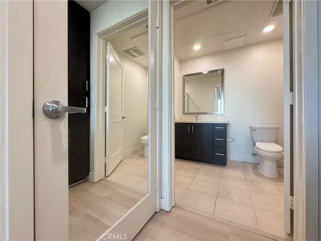 a bathroom with a sink a toilet and mirror