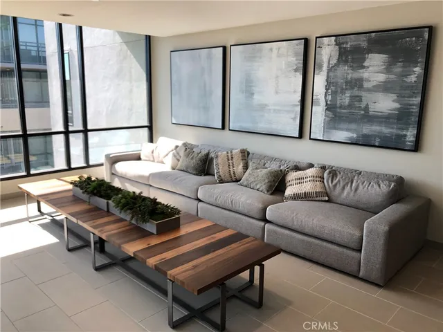 a living room with furniture and a painting on the wall