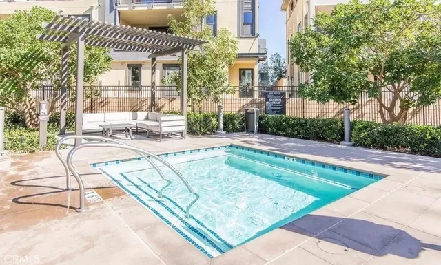a view of a house with a swimming pool and sitting area