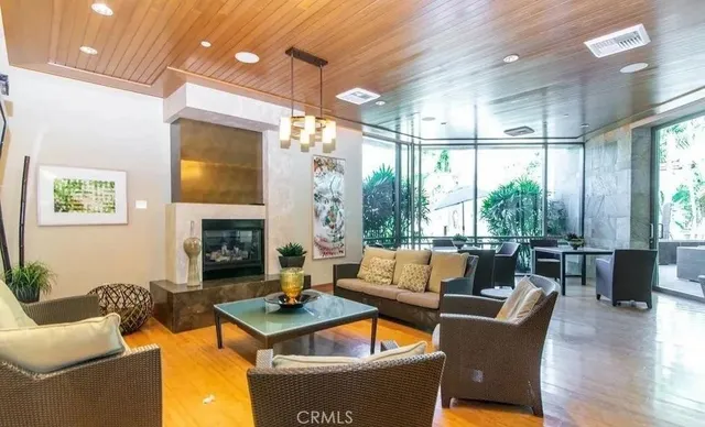 a living room with fireplace furniture and a large window