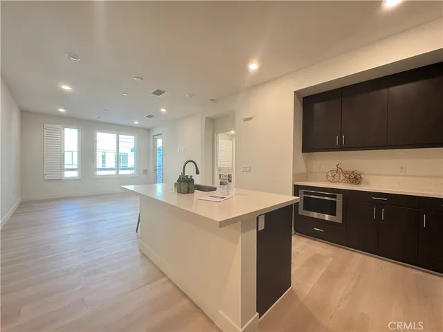 a kitchen with stainless steel appliances kitchen island granite countertop a sink and cabinets