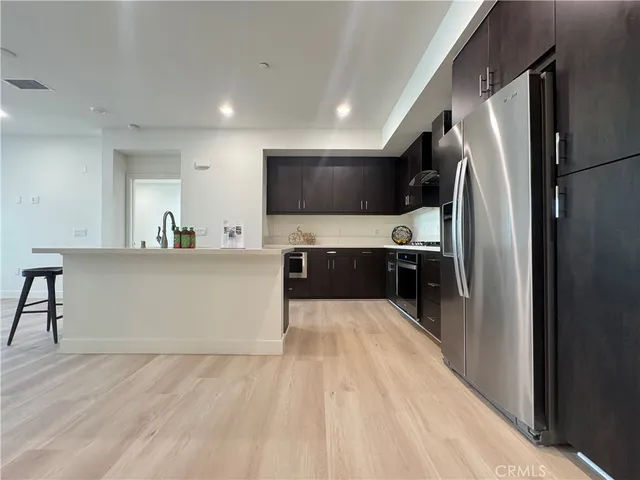 a kitchen with stainless steel appliances a refrigerator and a sink