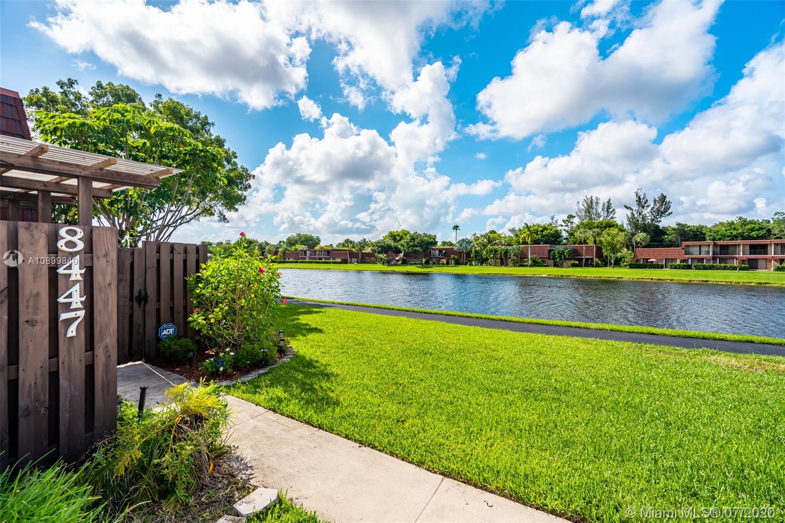 8447 Boca Rio Drive, Unit 8447 Boca Raton, FL 33433 - Photo 3 of 20 a view of a lake with a big yard