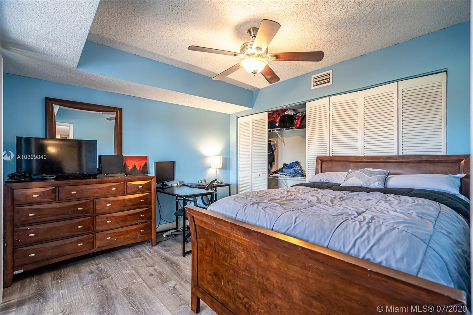 8447 Boca Rio Drive, Unit 8447 Boca Raton, FL 33433 - Photo 10 of 20 a bedroom with a bed and flat screen tv